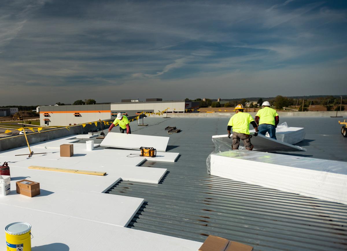 Commercial roofing crew performing an industrial roof inspection